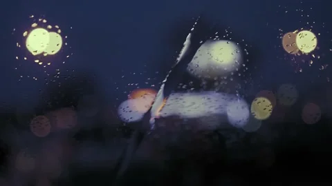 Rain Drops on the car windshield  and colourful traffic bokeh light. Video stock 147559541