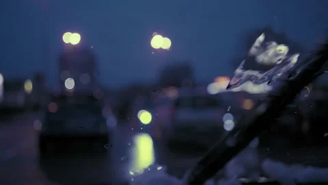 Rain Drops on the car windshield  and colourful traffic bokeh light. Video stock 147559855