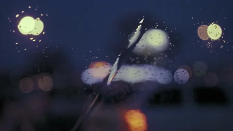 Rain Drops on the car windshield  and colourful traffic bokeh light. Video stock 147559873