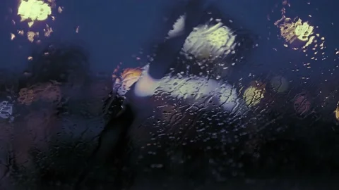 Rain Drops on the car windshield  and colourful traffic bokeh light. Video stock 147560300