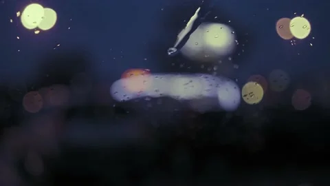 Rain Drops on the car windshield  and colourful traffic bokeh light. Video stock 147560421