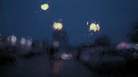 Rain Drops on the car windshield  and colourful traffic bokeh light. Video stock 147560544