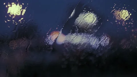 Rain Drops on the car windshield  and colourful traffic bokeh light. Video stock 147560604
