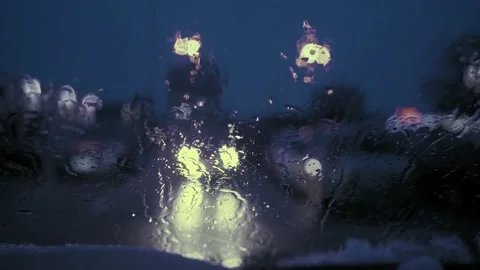 Rain Drops on the car windshield  and colourful traffic bokeh light. Video stock 147560650