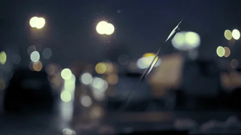 Rain Drops on the car windshield  and colourful traffic bokeh light. Video stock 147560685