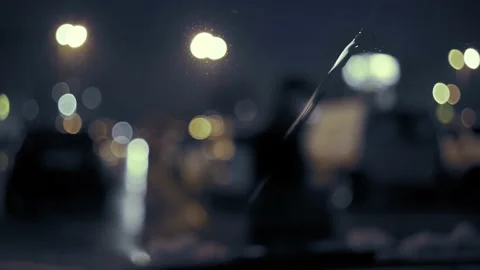 Rain Drops on the car windshield  and colourful traffic bokeh light. Video stock 147560757