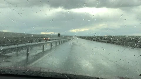 Rain drops on a car windshield. Rainy day view through a car window. Stockbeeldmateriaal 152642887