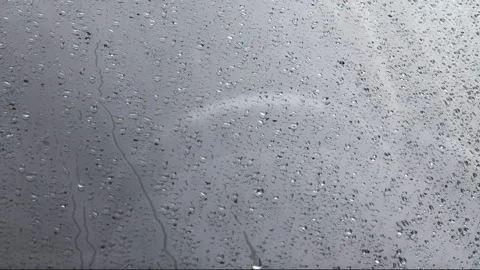 Rain drops on car windshield surface, closeup view from outside Stock Footage 273888906