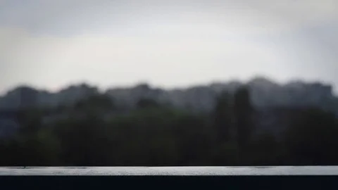 Rain drops close up with drops falling and city buildings behind in blur Stock Footage 75575249