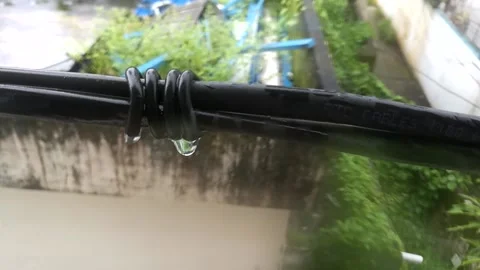 Rain drops dipping from a rope. Stock Footage 134625594