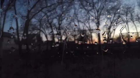Rain drops dripping down a window in a p... | Stock Video | Pond5