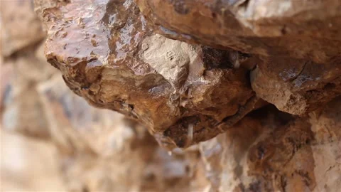 Rain drops dripping from Limestone in desert, Stock Footage 147010387