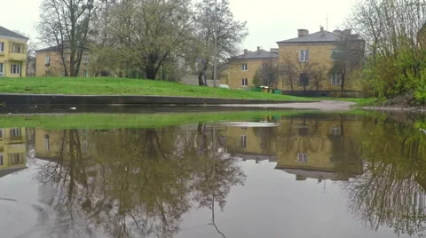 Rain drops dripping in a puddle Stock Footage 62352705