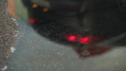 Rain drops dripping in a puddle on the road. Heavy water droplets falling on Stock Footage 251730883