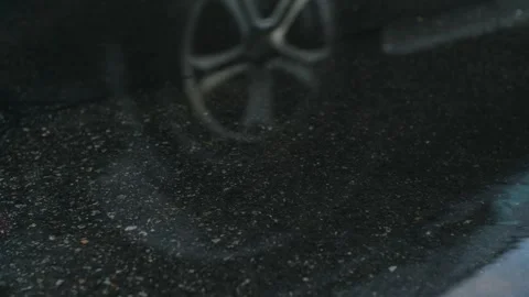 Rain drops dripping in a puddle on the road. Heavy water droplets falling on Stock Footage 251730908