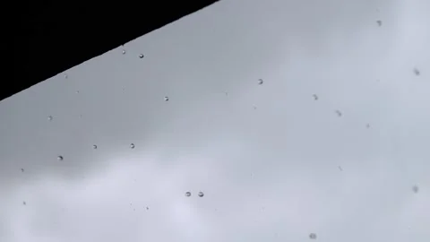 Rain drops fall from the edge roof, in super slow motion, 4k Stock Footage 204045417