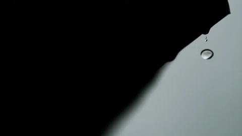 Rain drops fall from the edge roof, in super slow motion, 4k Stock Footage 204047789
