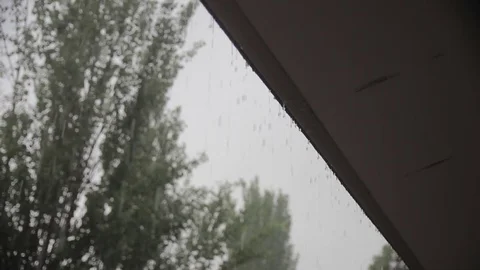Rain drops fall from roof Stock Footage 72771737