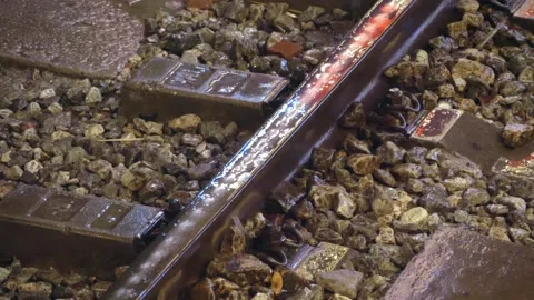 Rain drops fall slowly onto the rails and concrete sleepers  Stock Footage 303303377