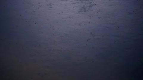Rain drops fall into the water. Sad rainy weather. Video recorded in slow motion Stock Footage 81080206