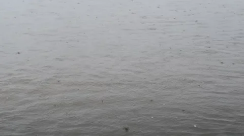 Rain drops fall on water surface Stock Footage 68749123