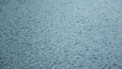 Rain drops fall on water surface of pond, lake or river Stock Footage 112484112