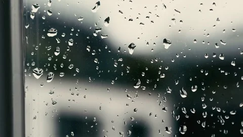 Rain drops fall on the window, pan right Video stock 73914880