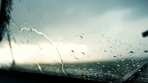 Rain drops falling and splashing on the car windshield. Wet misted window. Stock Footage 83041110