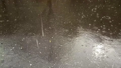 Rain drops falling on asphalt, road with wet surface texture 写真素材