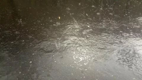 Rain drops falling on asphalt, road with wet surface texture 写真素材