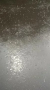 Rain drops falling on asphalt, road with wet surface texture 写真素材