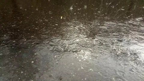 Rain drops falling on asphalt, road with wet surface texture Fotos Stock