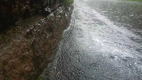 Rain drops falling on asphalt, road with wet surface texture 写真素材