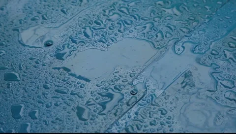 Rain drops falling on blue surface  Stock-Footage 2271224