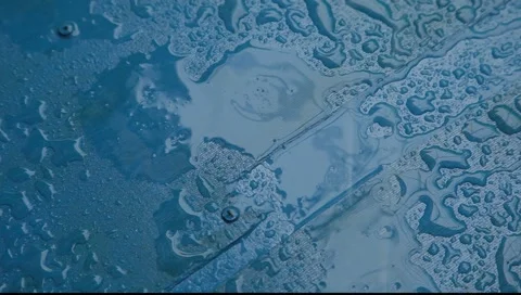 Rain drops falling on blue surface closeup Stock Footage 2271728