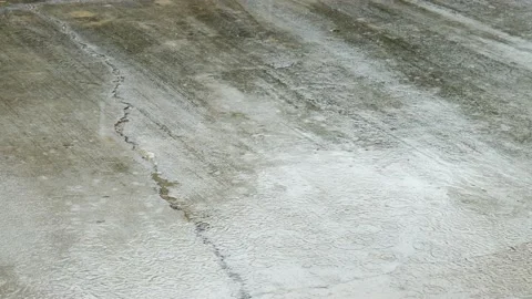 Rain drops falling to the concrete street. Video stock 153825251