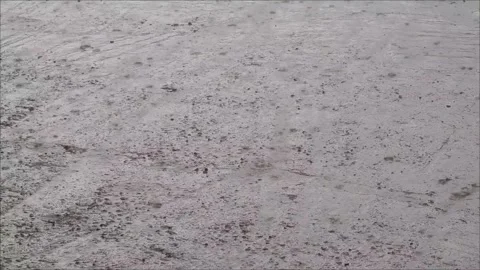 Rain drops falling on the concrete surface during rainy day Stock-Footage 307495981