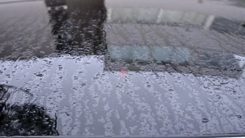 Rain drops falling on dark car roof glass during cloudy weather day with so.. Stock Footage 339661654