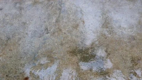 Rain drops falling on dirty wet concrete floor on a rainy day Stock Footage 132787750