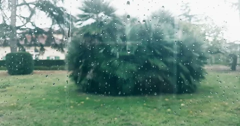 Rain drops falling down on glass blue background, water droplets on window Video stock 105780764