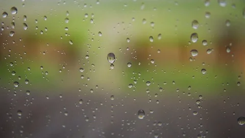 Rain drops falling down on glass Stock Footage 108775929
