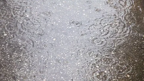 Rain drops falling on ground Stock Footage 76099444