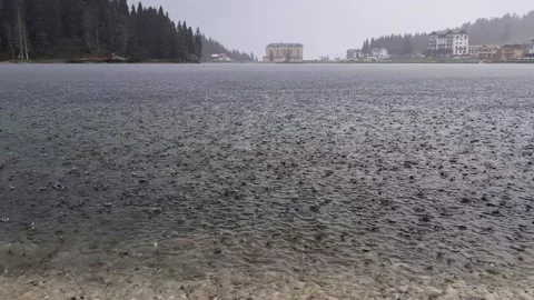 Rain drops falling on the lake surface, rainy day at Misurina lake Dolomites Video stock 320332238