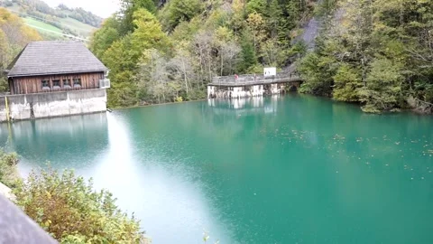 Rain drops falling in to a little nice turquoise lake Stock Footage 218574370