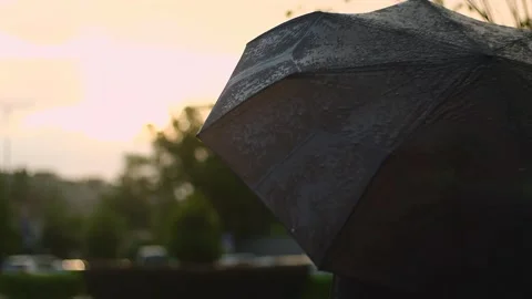 Rain drops falling on open umbrella. Slow motion drop of water droplets on black Stock Footage 251736532