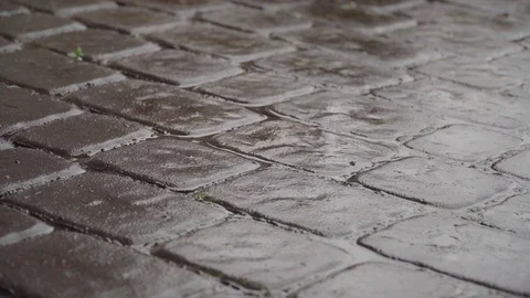 Rain Drops falling on paving stones, Close-Up Stock Footage 121376380