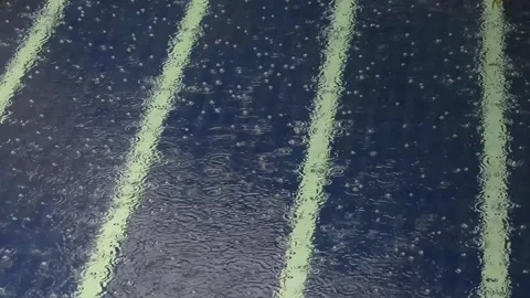 Rain drops falling on a pool Video stock 296819759