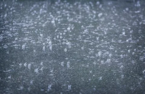 Rain drops falling in pool Stock Photos