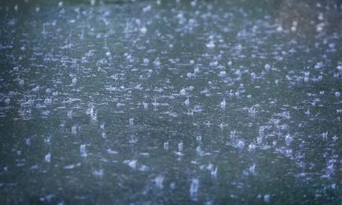 Rain drops falling in pool Stock Photos