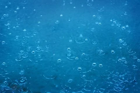 Rain drops falling in pool Stock Photos